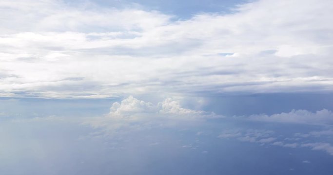 Flight over clouds, a view from a plane window - beautiful blue sky
