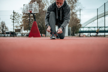 Older guy getting ready to play some basketball.