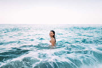 Portrait of a beautiful woman going for a swim in the sea.