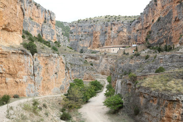 The Our Lady of Jaraba Sanctuary in the Barranco de la Hoz Seca canyon (Dry Defile Gully) in the Aragon region, Spain, during a sunny summer day