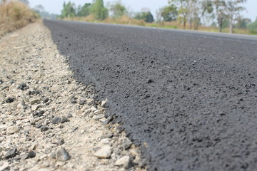 asphalt road in field