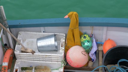 Looking down onto a fishing boat deck and its oilskins and various fishing gear, St Ives.