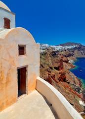 Old church dome and entrance to Church. view of Fira city and the slope with mediterranean sea in Oia, Santorini