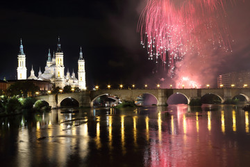 The fireworks during the 2018 Pilar festival next to the Pilar Cathedral and the Stone Bridge over the Ebro river, in Zaragoza, Aragon region, Spain