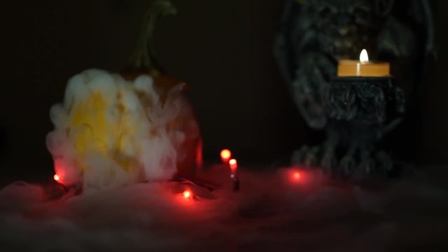 a gargoyle and pumpking in the mist, halloween creepy stuff