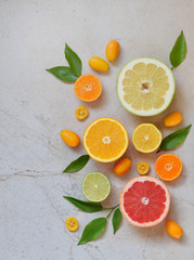 Set of citrus on light background: orange, mandarin, lemon, grapefruit, lime, kumquat, tangerine. Fresh organic juicy fruits. Source of vitamin C. Healthy food concept