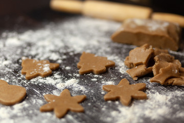 Figures Christmas trees, snowflakes from raw dough for holiday cookies