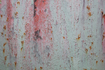 metal rusty sheet with remnants of red and green paint texture