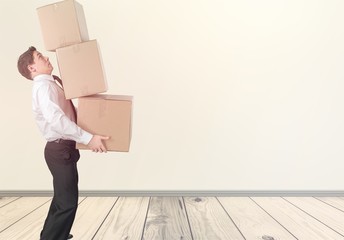 Moving. lots of cardboard boxes and man on background