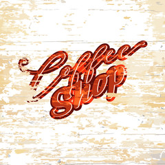 Coffee shop lettering on wooden background