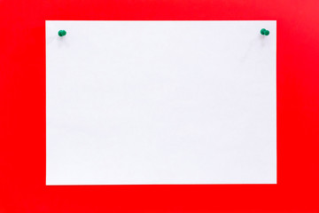 Blank white paper with push pins on red board. Concept to do and check list