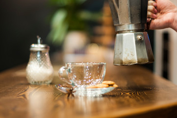 The concept of morning coffee. Pour the morning coffee. A quick revival. Old Italian coffee machine.