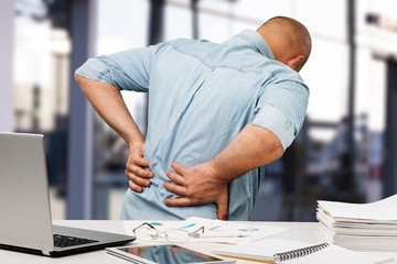 Business man with back pain an office