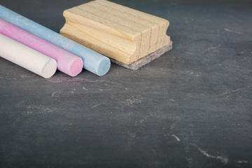 Coloured chalk over chalkboard. Selective focus