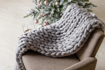 Christmas or New Year background: lamp, pink glass balls and toys, powder decoration, wool blanket