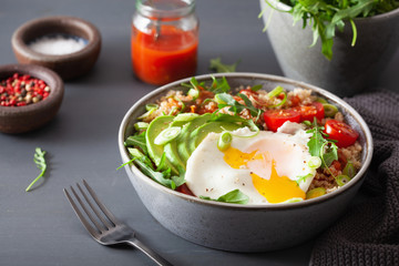 quinoa bowl with fried egg, avocado, tomato, rocket. Healthy vegetarian lunch