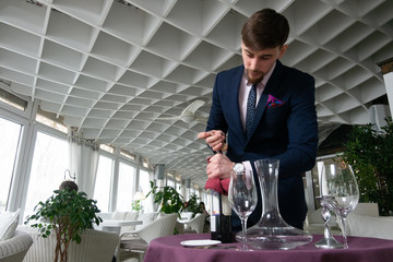 the young male sommelier while tasting red wine