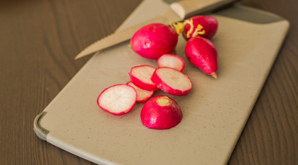 Pile of fresh ripe radishes on grey background