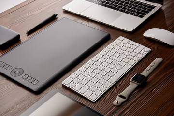 close-up shot of various gadgets on graphics designer workplace