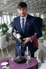 the young male sommelier while tasting red wine