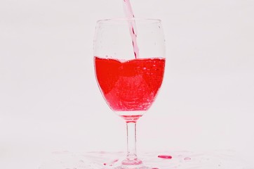 Pour the red beverage into a beautiful glass.