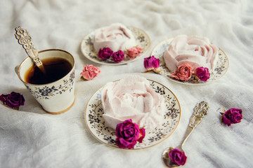 Homemade marshmallow with fresh raspberries on a textile background with a Cup of coffee. The concept of dessert and a break for sweets.