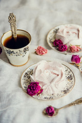 Homemade marshmallow with fresh raspberries on a textile background with a Cup of coffee. The concept of dessert and a break for sweets.