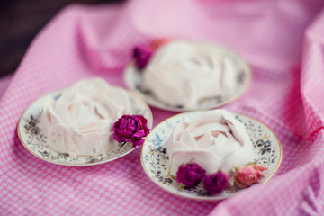 Homemade marshmallow with fresh raspberries on a textile background with a Cup of coffee. The concept of dessert and a break for sweets.
