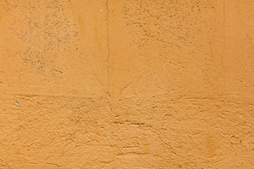 Old wall painted with yellow paint as a background
