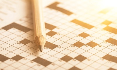 Crossword Puzzle and Pencil on background