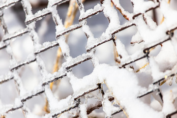 Snow and ice on a metal grid as a background