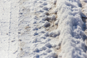 Traces of cars in the snow as a background