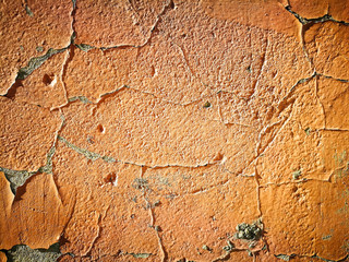 Old cracked wall with orange paint as background