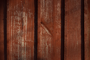 Texture of old wood with cracked paint of red color