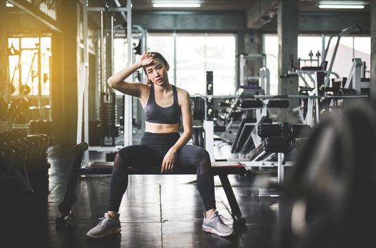 Fit woman sitting and relax after the training session in gym,Female taking  a break after exercise and workout Stock Photo | Adobe Stock