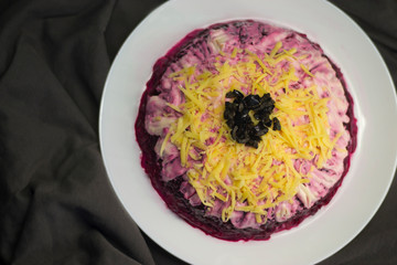 The national Russian dish is prepared in layers of salted herring, potatoes, beets, carrots, eggs.
