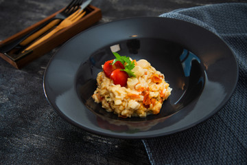 Tasty risotto with Shrimp, fresh herbs vegetables on a white plate