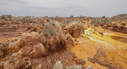 Dallol is an active volcanic crater in the Danakil Trench, Ethiopia. The volcano is known for its extraterrestrial landscapes resembling the surface of Io, the satellite of the planet Jupiter.