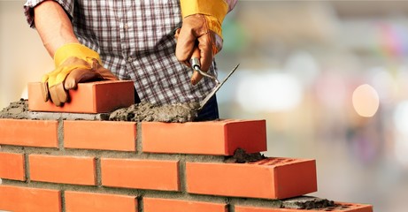 Worker builds a brick wall