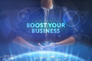 The concept of business, technology, the Internet and the network. A young entrepreneur working on a virtual screen of the future and sees the inscription: Boost your business
