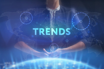 The concept of business, technology, the Internet and the network. A young entrepreneur working on a virtual screen of the future and sees the inscription: Trends