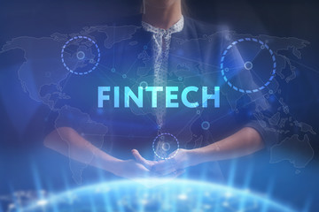 The concept of business, technology, the Internet and the network. A young entrepreneur working on a virtual screen of the future and sees the inscription: Fintech