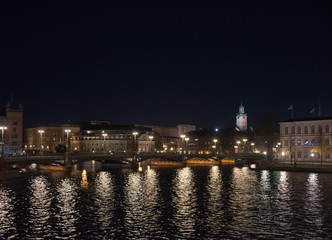 Fototapeta na wymiar Evening view in Stockholm shilouettes of old town, parliament houses , bridges and lake Mälaren