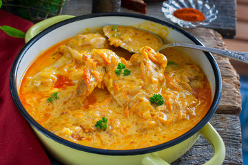 Pumpkin paprikash with chicken in a rustic style, horizontal