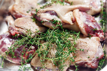 Raw marinated red duck meat cut into pieces with thyme, salt and pepper close-up. Banquet concept in a restaurant in honor of anniversary and birthday, cake mix, preparation