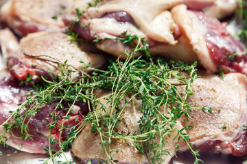 Raw marinated red duck meat cut into pieces with thyme, salt and pepper close-up. Banquet concept in a restaurant in honor of anniversary and birthday, cake mix, preparation