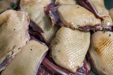 Raw marinated red duck meat cut into pieces with thyme, salt and pepper close-up. Banquet concept in a restaurant in honor of anniversary and birthday, cake mix, preparation