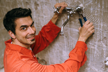 Naklejka premium Handyman removing the old tap