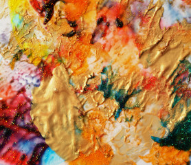 Abstract color gold background. Acrylic paint with sparkles. Colorful blots. Marble texture.