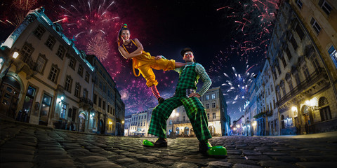 Night street circus performance whit clown, juggler. Festival city background. fireworks and...